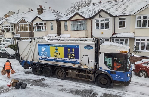 Refuse truck in snow