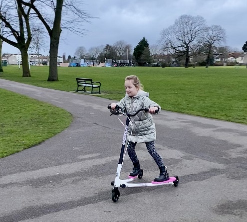 Young girl on scooter in Cottons Park
