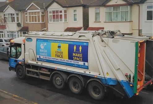 Refuse truck with hands face space banner 495px