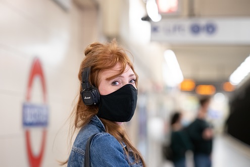 Woman wearing mask on tube platform