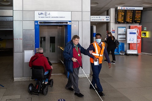 TfL staff helping disabled apssenger
