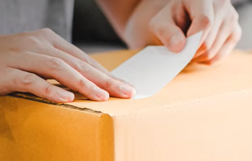 Picture of parcel being labelled for sending in the post