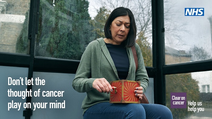NHS Cancer campaign warning image of woma at bus stop