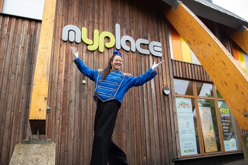 Woman on stilts outside myplace