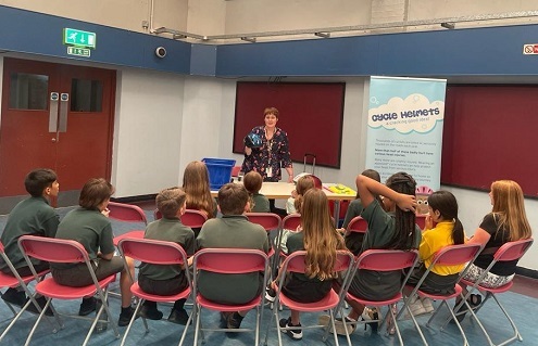 Children in a room attending a Junior Citizens event regarding cycling