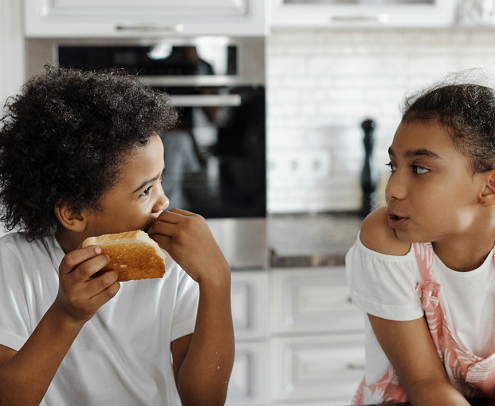 two young kids eating food