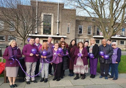 Volunteers in purple at the Town Hall for International Volunteers Day