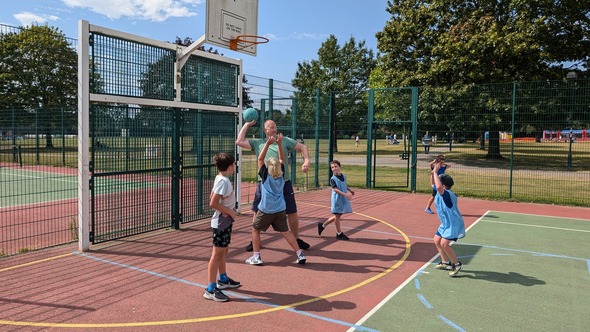 Cllr Ray Morgon joins children at the police Clear Hold Build sports events