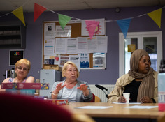 Residents sitting around a table chatting