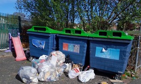 Fly-tipped rubbish near bins