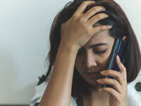Image of upset woman on phone