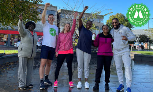 Beginners Bootcamp attendees posing with their arms raised 