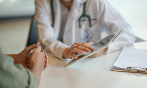 Doctor showing a patient something on a tablet