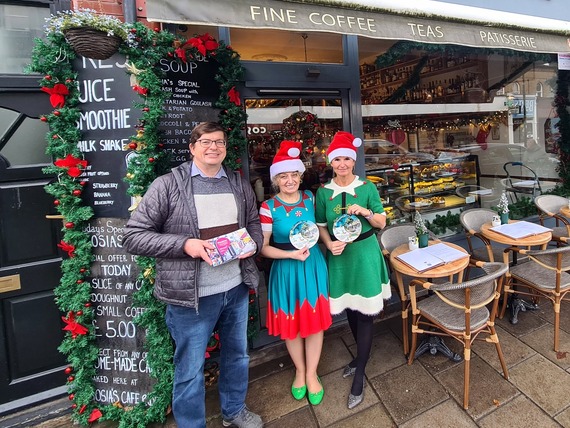 Small Business Saturday - Cllr Phil Giesler outside of a store with two staff members dressed as Christmas elves