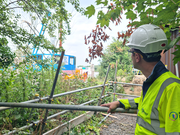 Cllr Alexander Ehmann on site at the towpath breach site, watching piling works taking place from a safe distance