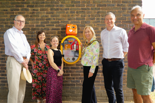people standing near a defibrillator