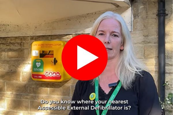 women in front of a defibrillator