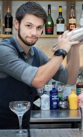 person making cocktail