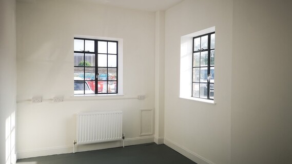 image of white walled studio with two square windows