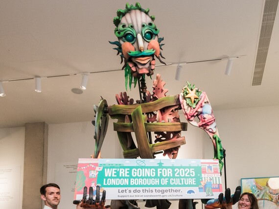 Giant puppet holding LBOC banner