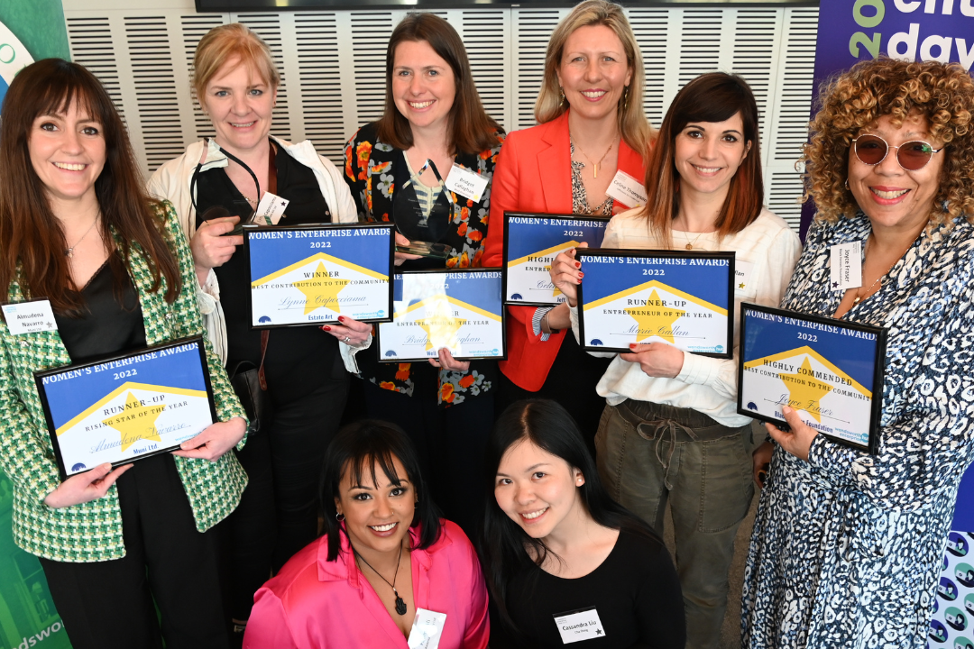 women holding paper awards
