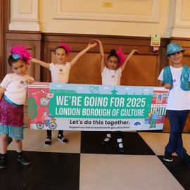 3 girls and one boy hold london borough of culture sign