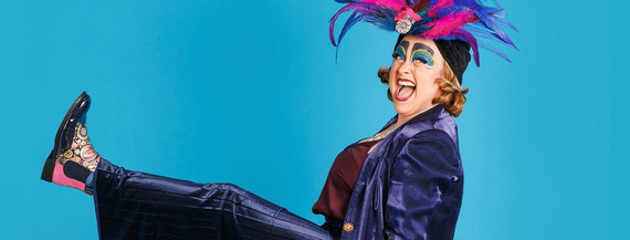 woman wearing feather hat kicks leg in air