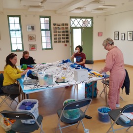 Four Artists Work Together On A Piece Whilst Drinking Tea