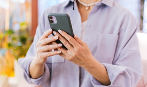 woman looking at mobile phone