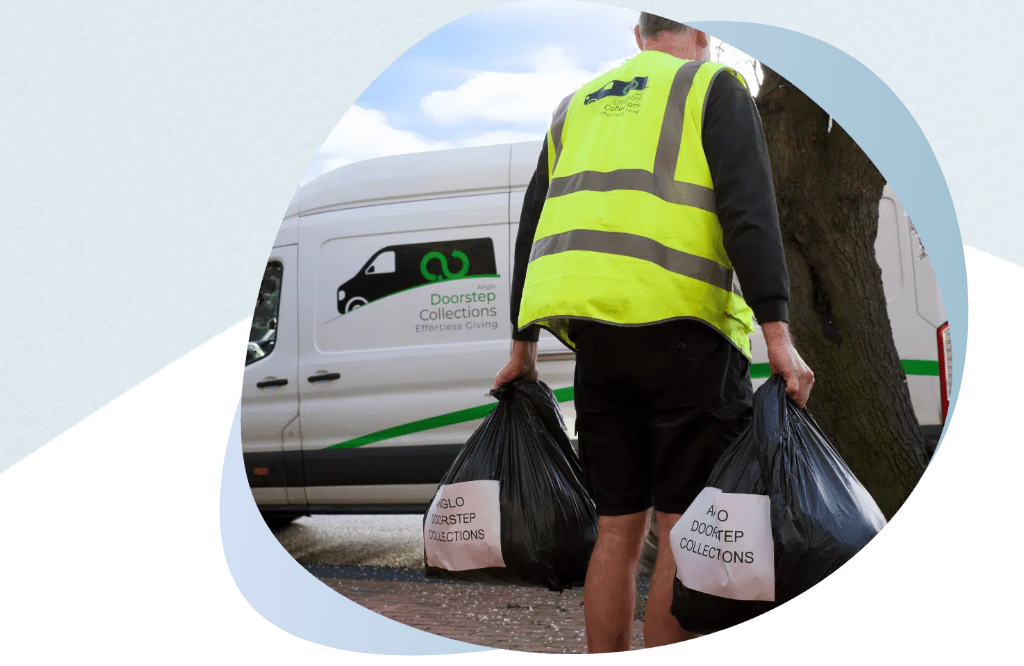 Man carrying bags of recycling to an anglo doorstep van