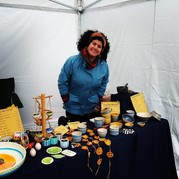 Image of local business owner with ceramics