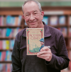 Chris Nickson holding a book