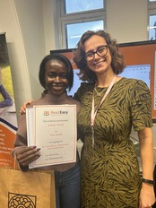 A reading coach and her reader posing for a photo