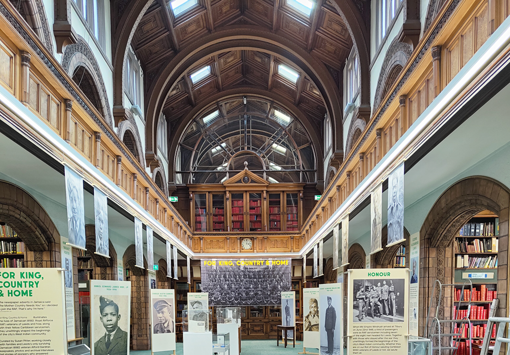 Colour photograph showing exhibition banners in a traditional library setting 
