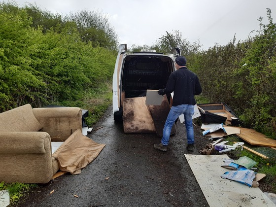 Man fly tipping from a van 