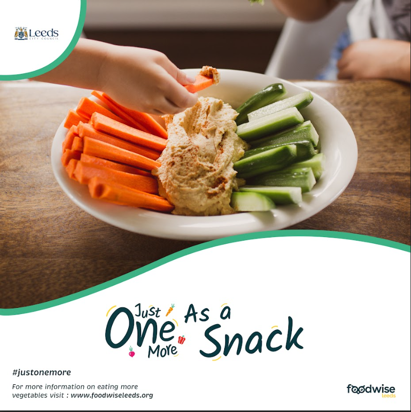 A bowl of vegetables is shown with a dip in the centre