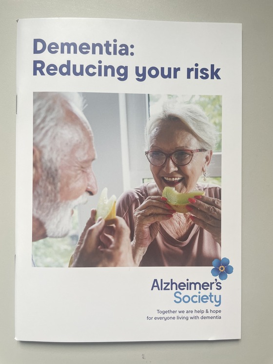 An older man and woman eating fruit 