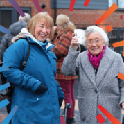 Chair our Board and a customer standing next to each other