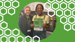 Two people standing next to each other one is holding a certificate