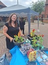 Woman stood behind a table with plant pots on top 