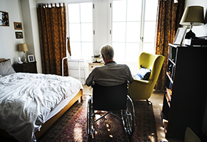 Older man in care home room