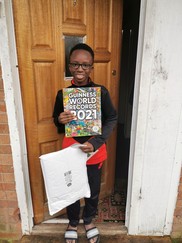 Young girl with copy of Guiness book of records 2021
