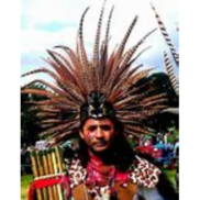 Man in head dress holding pan pipes