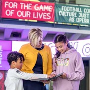 Family looking at a brochure in the National football museum
