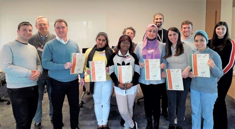 group of smiling people holding certificates