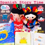 Spanish storytime with books in Spanish and two black haired Spanish dolls.