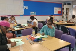 adult learners working in a maths classroom