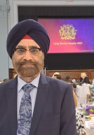 a brown-skinned man in suit and turban at the Council's Long Service Awards