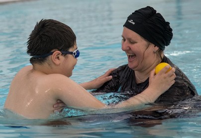 Parent and child in swimming pool