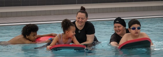 Parent with children in pool